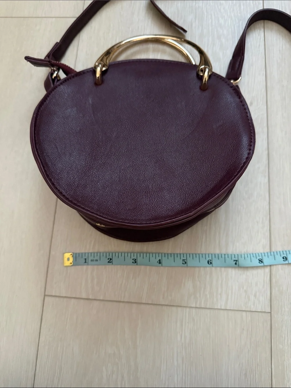 Round Crossbody Bag in Plum with Gold Accents